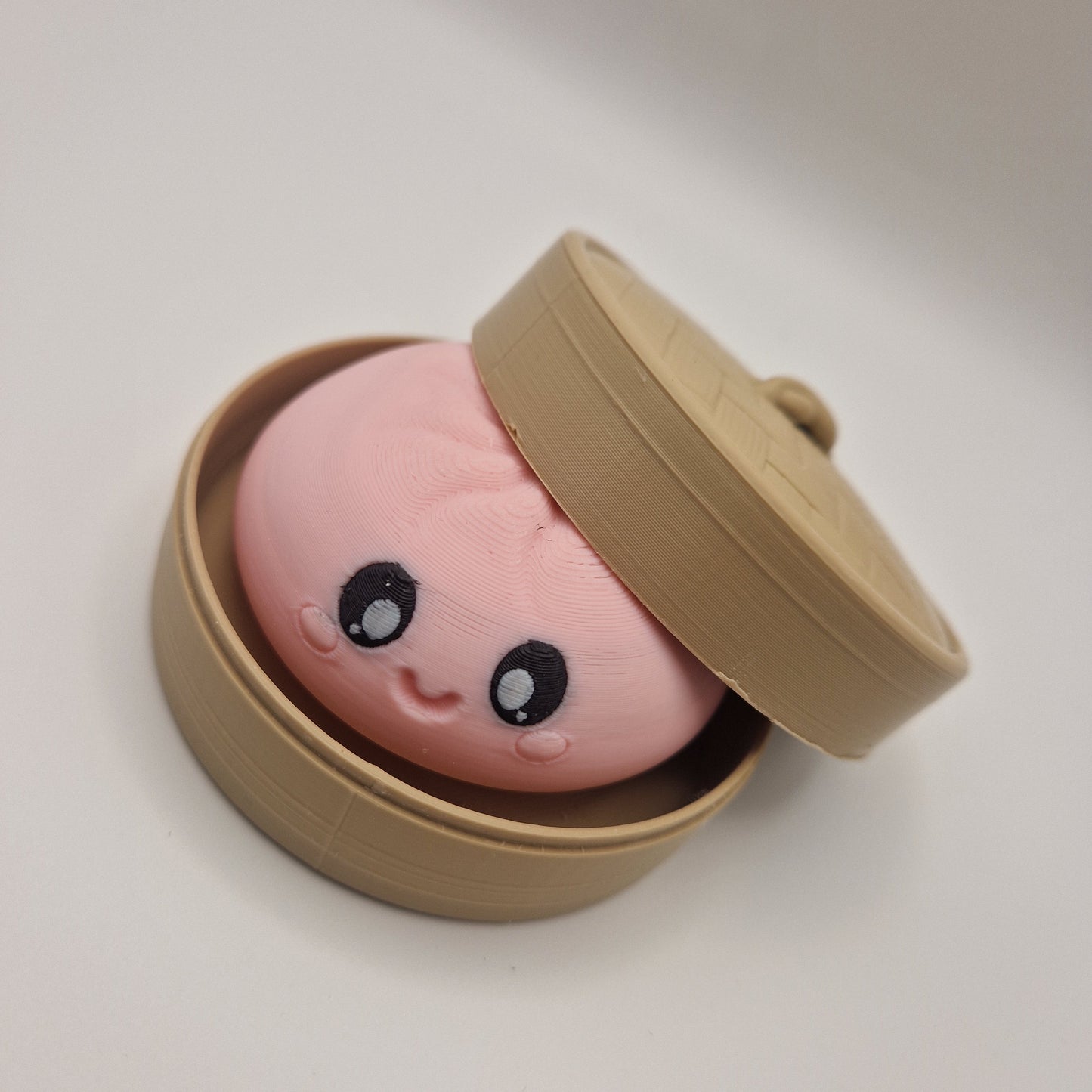 3d printed Dumpling clickers in steamer basket