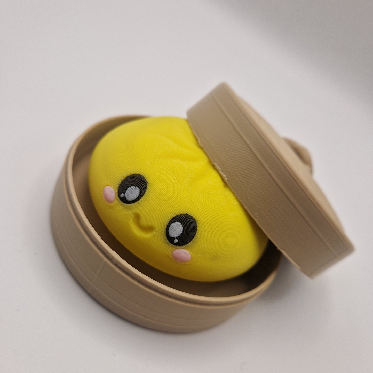 3d printed Dumpling clickers in steamer basket