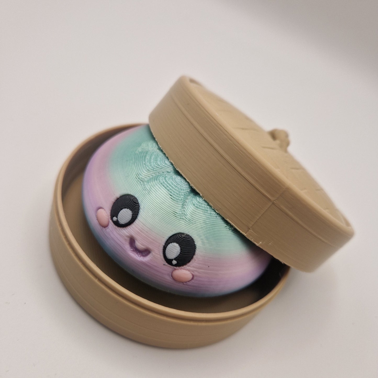 3d printed Dumpling clickers in steamer basket