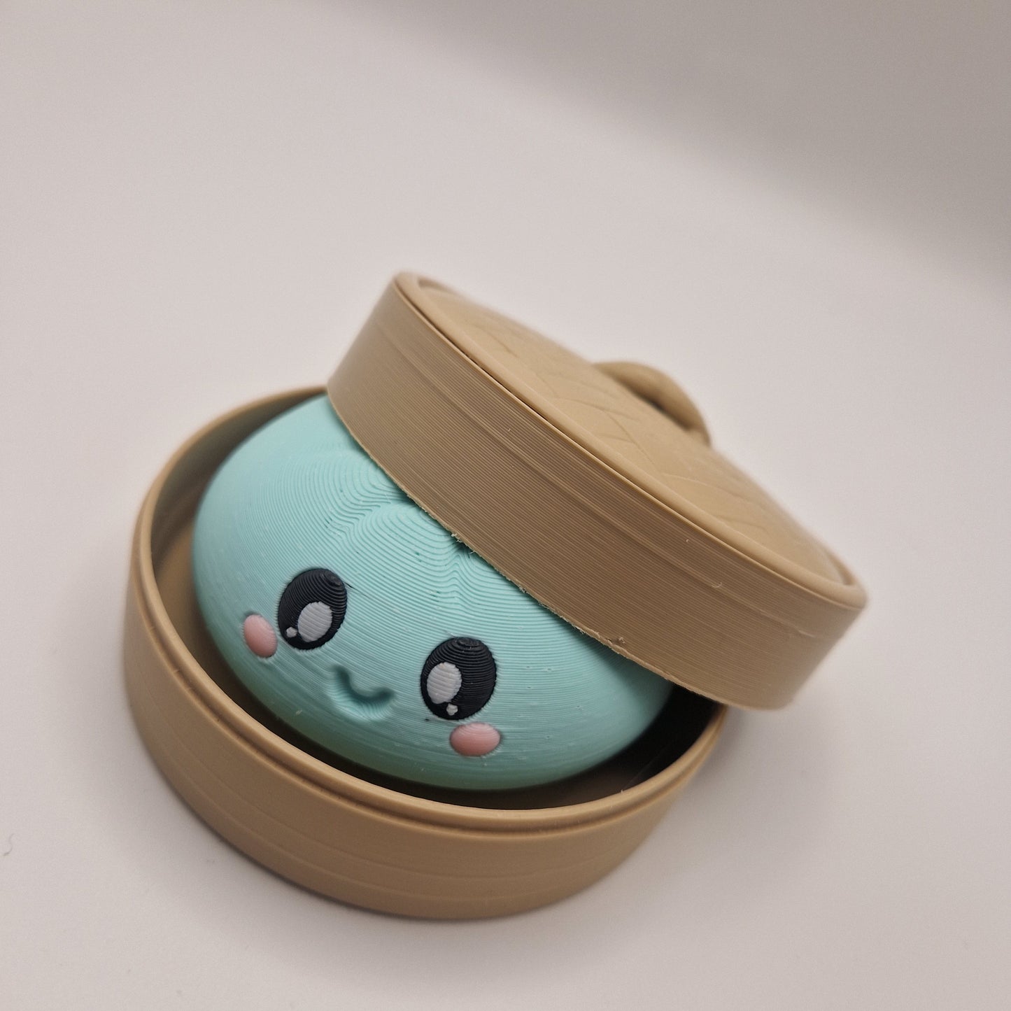 3d printed Dumpling clickers in steamer basket